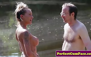 Busty femdom tugging guy outdoors for keep in check